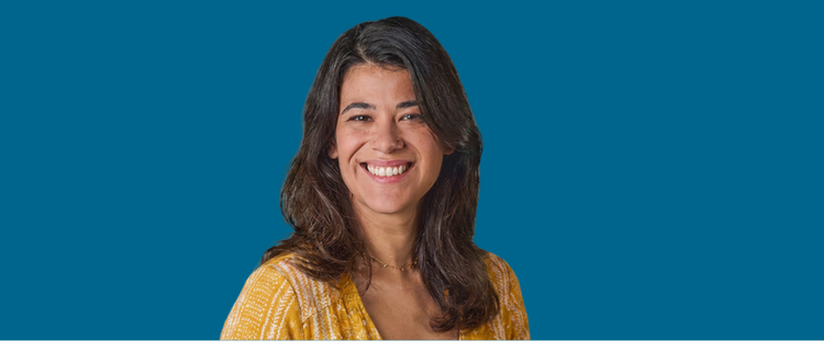 Adult woman smiling with blue background
