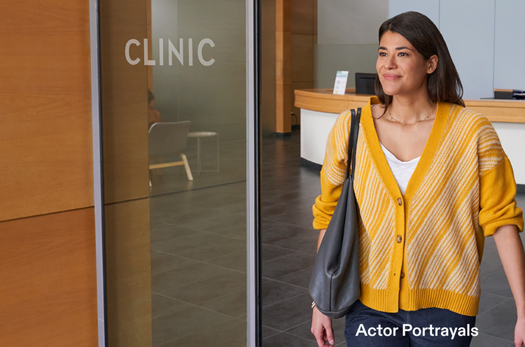 Actor portrayal of an adult woman walking out of a healthcare clinic