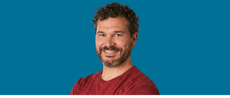 Adult man smiling with blue background