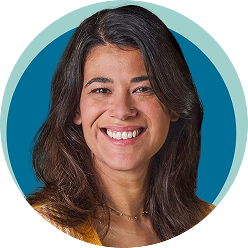 Adult woman smiling with blue background