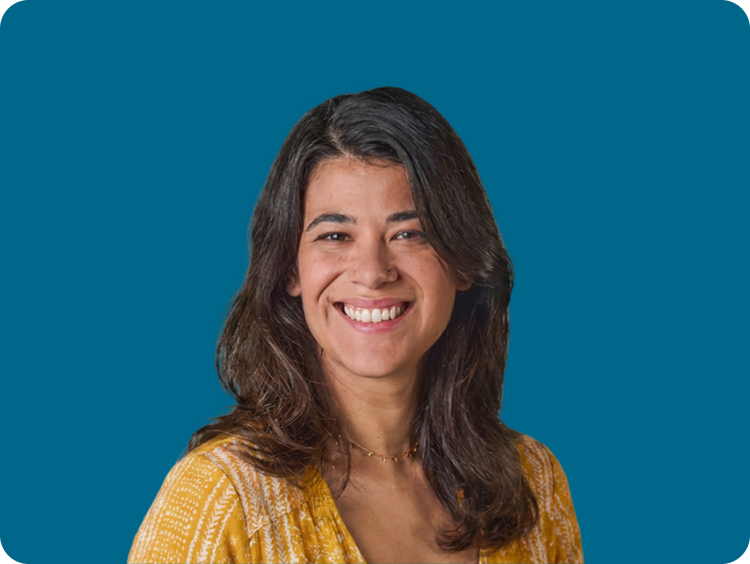 Adult woman smiling with blue background