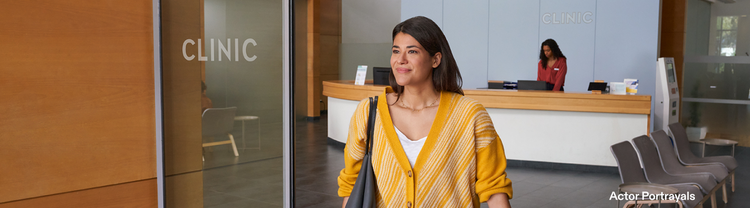 Actor portrayal of an adult woman walking out of a healthcare clinic