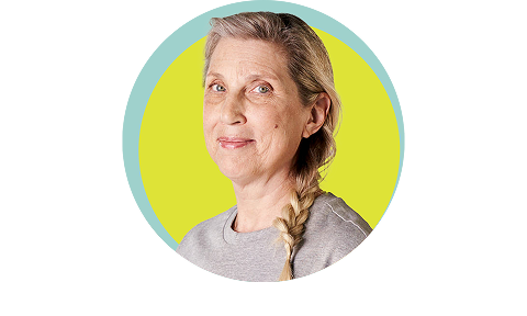 50+ year old woman smiling with yellow background