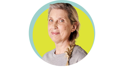 50+ year old woman smiling with yellow background